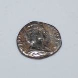 AN ANTIQUE ROMAN WHITE METAL COIN