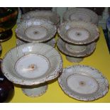 A VICTORIAN POTTERY OFF-WHITE AND GILT PART FRUIT SET COMPRISING PLATES, COMPORTS AND OVAL SHAPED