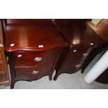 A PAIR OF 20TH CENTURY MAHOGANY BEDSIDE CHESTS, WITH SERPENTINE TOPS AND TWO DRAWERS