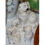 TWO GRADUATED BESWICK POTTERY STAFFORDSHIRE KING CHARLES SPANIELS AND A SIMILAR PAIR OF ROYAL