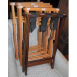 A MAHOGANY FOLDING LUGGAGE STAND, TOGETHER WITH FOUR OTHER FOLDING LUGGAGE STANDS