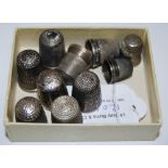 A COLLECTION OF NINE ASSORTED SILVER THIMBLES AND A PLATED THIMBLE