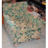 A GREEN FLORAL UPHOLSTERED ARMCHAIR