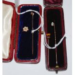 A VINTAGE LEATHER-CASED YELLOW METAL COMBINATION STICK PIN/ STUD WITH PEARL AND DIAMOND FLOWER