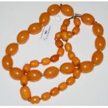 TWO YELLOW COLOURED AMBER TYPE BEAD NECKLACES