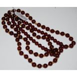 TWO RED AMBER TYPE BEAD NECKLACES