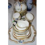 A TUSCAN CHINA ART DECO STYLE BLUE, BLACK, GREEN AND GILT PART TEA SET WITH RETAILERS MARK FOR "