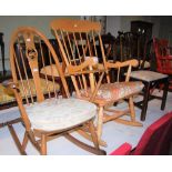 AN ERCOL SPINDLE BACK ROCKING CHAIR, TOGETHER WITH A PINE ROCKING CHAIR, AND A GEORGE III STYLE