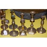 A COLLECTION OF NINE ASSORTED BRASS CANDLESTICKS