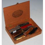 A CIGAR BOX CONTAINING A COLLECTION OF ASSORTED POCKET KNIVES