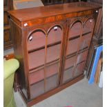 A MAHOGANY GLAZED BOOKCASE, DOUBLE DOORS OPENING TO AN INTERIOR WITH THREE ADJUSTABLE SHELVES