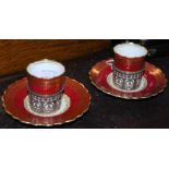 A PAIR OF AYNSLEY CERAMIC STERLING SILVER MOUNTED COFFEE CANS AND SAUCERS WITH PUCE AND GILT
