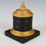 A Regency style bronze inkwell and cover, cast with three shelves of books, on a square plinth base,