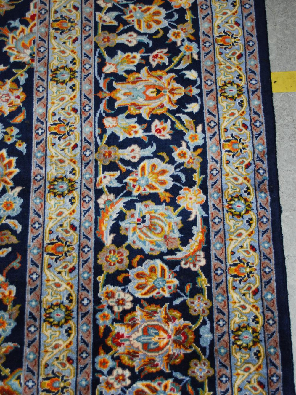 A Persian carpet, Isfahan, 20th century, the blue ground with all-over design of scrolling flowers - Image 6 of 8