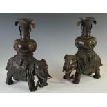 A pair of Chinese bronze elephant incense burners, Qing Dynasty, modelled in two sections, the upper
