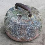 An antique curling stone, with loop handle, 23cm diameter