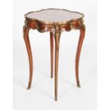 A late 19th/ early 20th century gilt metal mounted mahogany occasional table, the shaped circular