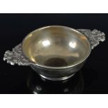 A 19th century plated-brass quaich, with cast thistle handles, the base inset with an early Scottish