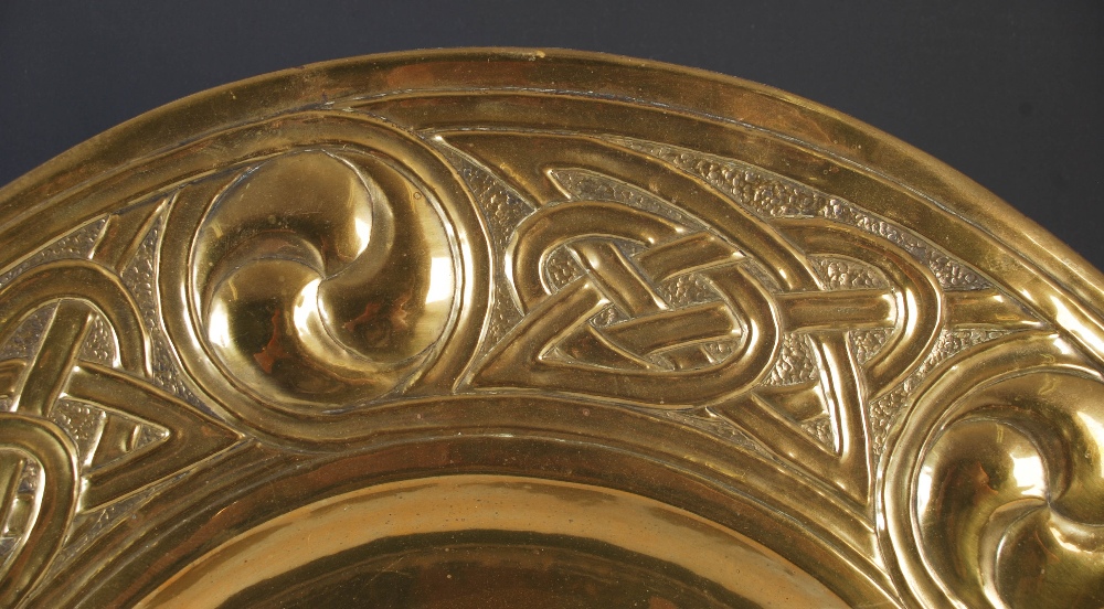 An early 20th century Scottish Arts and Crafts brass charger, with embossed decoration of six - Image 2 of 3