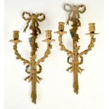 A pair of late 19th century gilt metal two light wall sconces, with ribbon tied and foliate cast