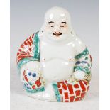 A small Chinese porcelain figure of Buddha, 20th century, 11.5cm high.