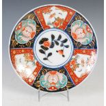 A Japanese Imari dish, late 19th/ early 20th century, decorated with a central roundel enclosing a