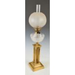 A late 19th/ early 20th century brass Corinthian column oil lamp, with frosted glass shade, the