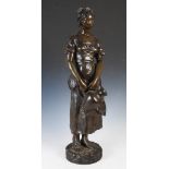 After Anatole Guillot, a late 19th / early 20th century bronze figure of a water carrier, signed