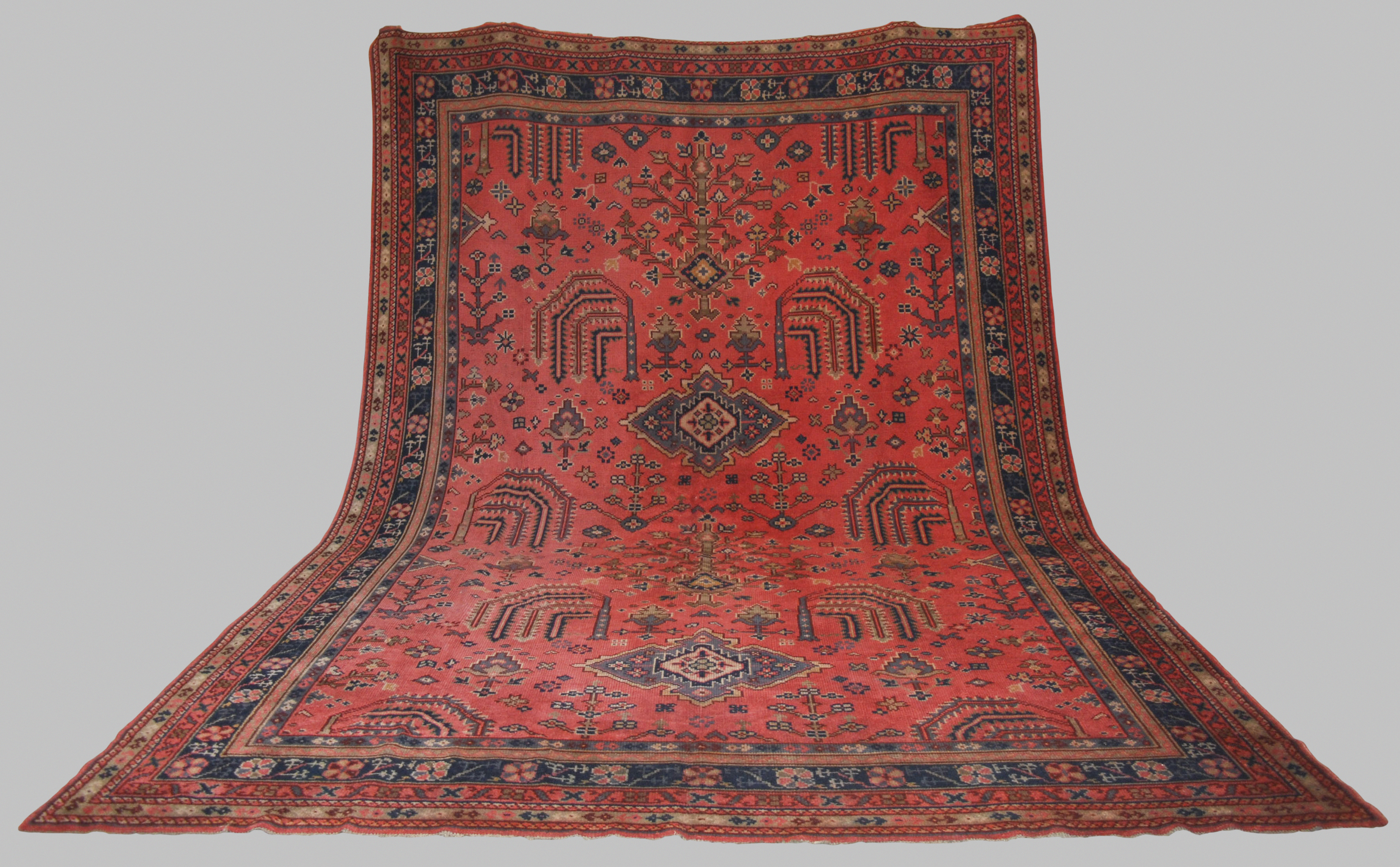 A late 19th/ early 20th century Ushak carpet, the madder ground decorated with flowers and