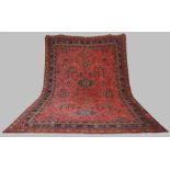 A late 19th/ early 20th century Ushak carpet, the madder ground decorated with flowers and