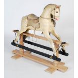 A carved and painted wood rocking horse in the style of F. H. Ayres, with inlaid eyes, horse hair