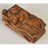A mid 19th century 'blind man' table snuff box, the cover carved in high relief with a depiction