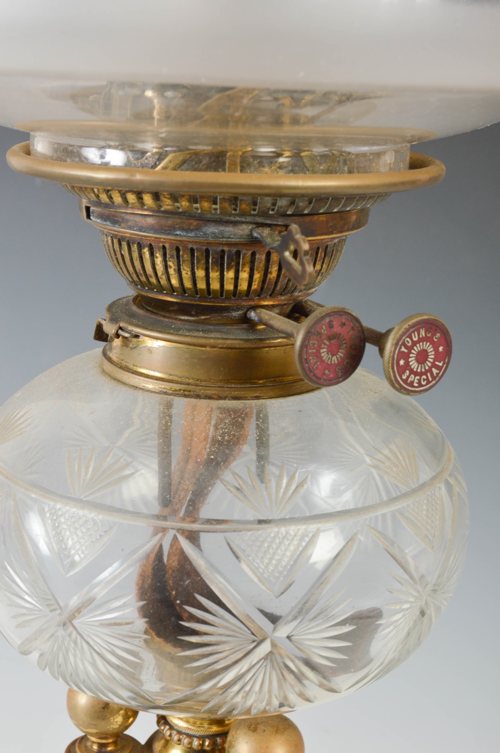 A late 19th/ early 20th century brass oil lamp, with clear and frosted cut glass shade, the burner - Image 2 of 3