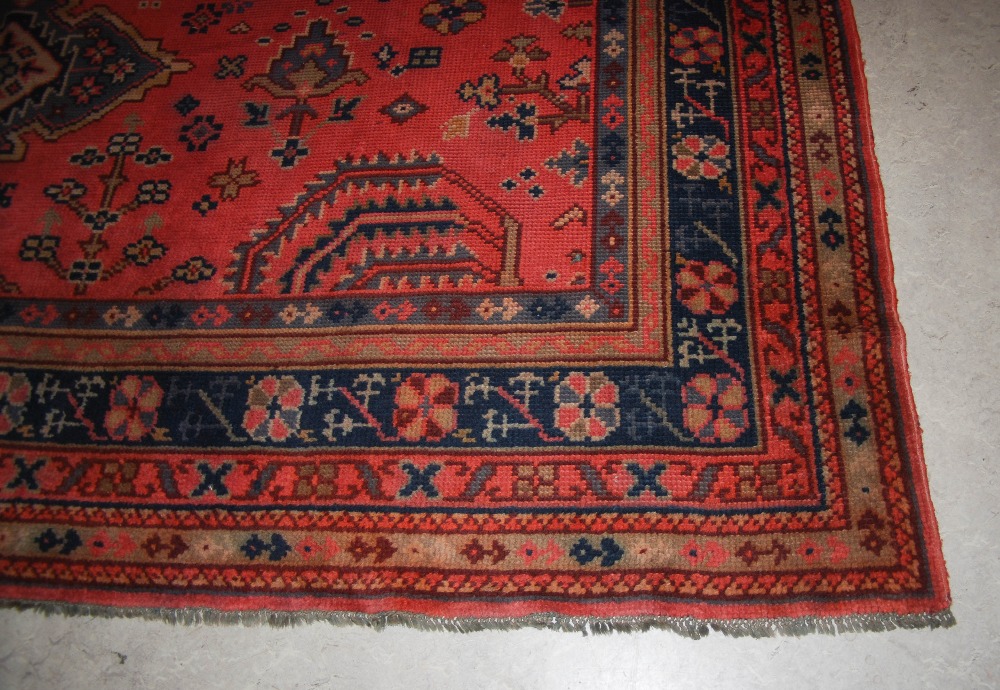 A late 19th/ early 20th century Ushak carpet, the madder ground decorated with flowers and - Image 2 of 8