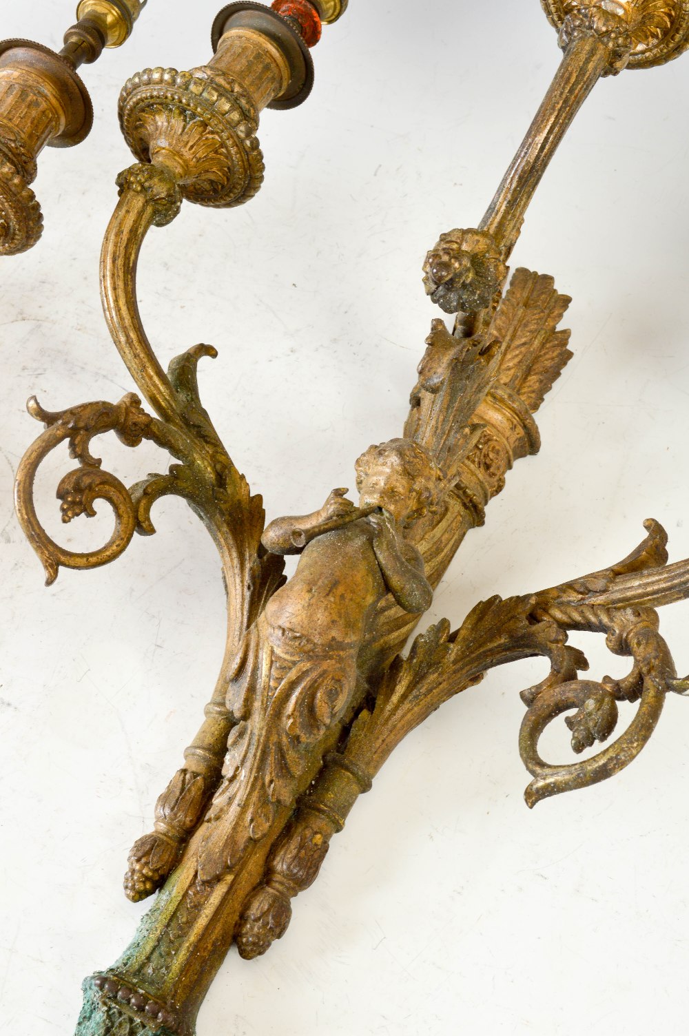 A pair of late 19th century gilt metal three light wall sconces, each cast with a cherub playing - Image 2 of 3