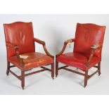 A pair of George III style mahogany Gainsborough armchairs, the red leather upholstered back, arms