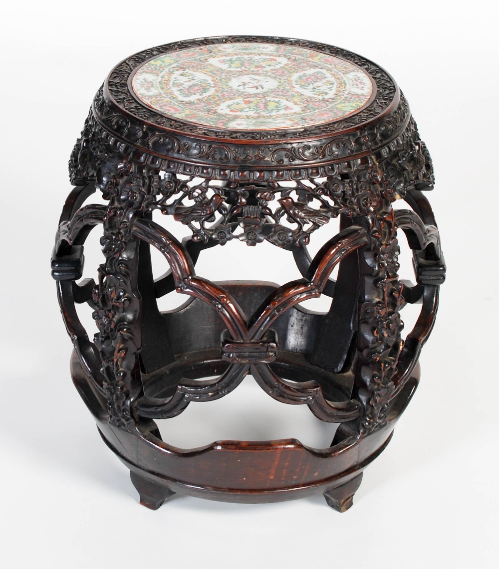 A Chinese darkwood and porcelain mounted barrel-shaped stool, Qing Dynasty, the circular top inset