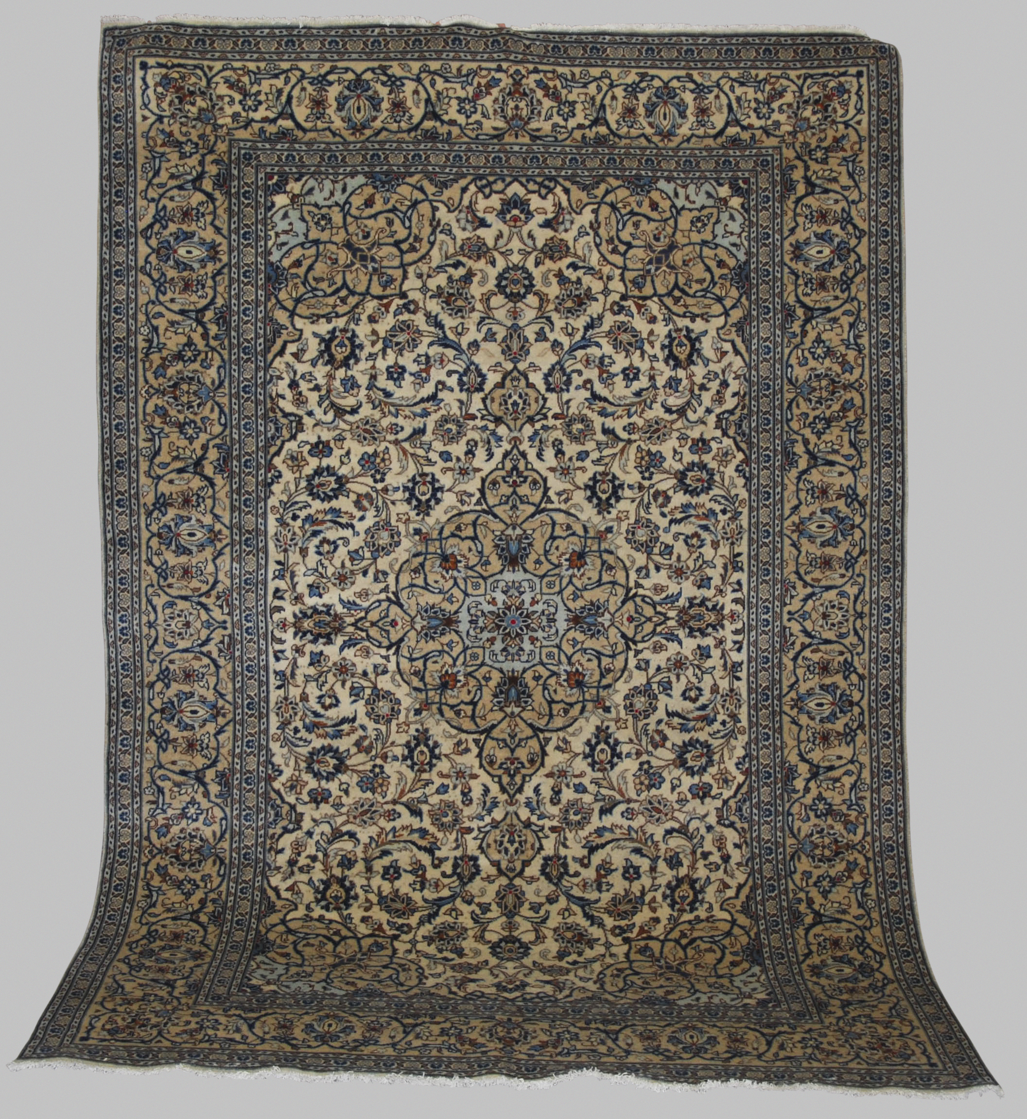 A Persian rug, Kashan, 20th century, the ivory ground decorated with all-over design of scrolling
