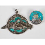 Alexander Ritchie, a white metal and enamel pendant, decorated with a bird on a blue/ green enamel
