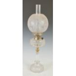 A late 19th/ early 20th century white metal mounted glass oil lamp, with frosted glass shade, the