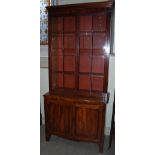 A 19th century mahogany bookcase, the moulded cornice above a pair of astragal glazed cupboard doors