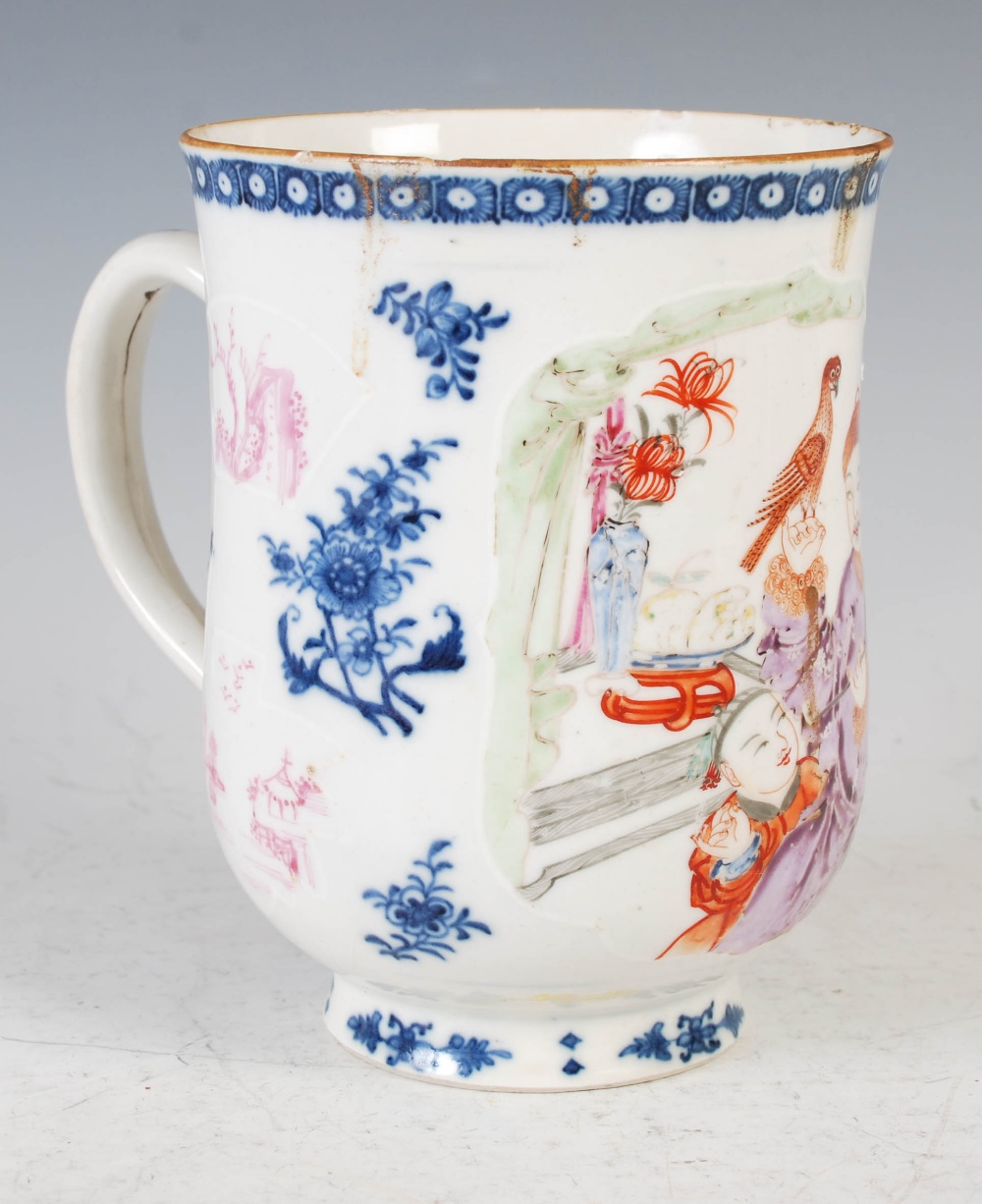 A Chinese porcelain blue and white tankard, Qing Dynasty, decorated in famille rose enamels with