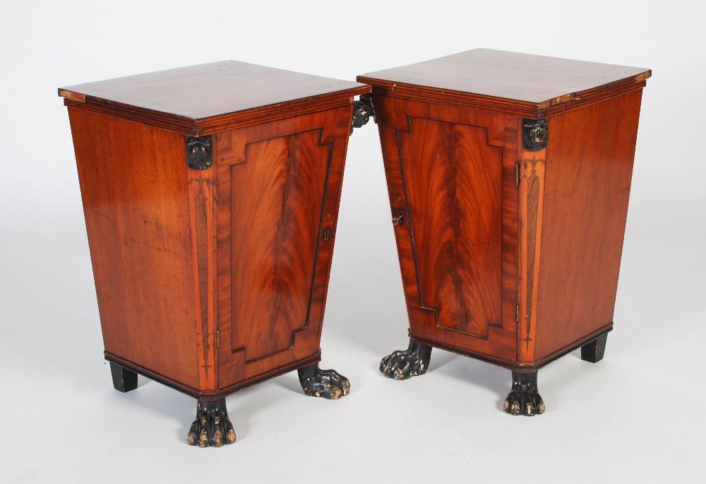 A pair of 19th century mahogany and ebony lined pedestal cupboards, the rectangular tops above a