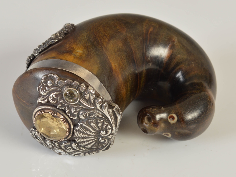 A 19th century curled horn snuff mull, the terminal in the form of a stylised seal's head with inset