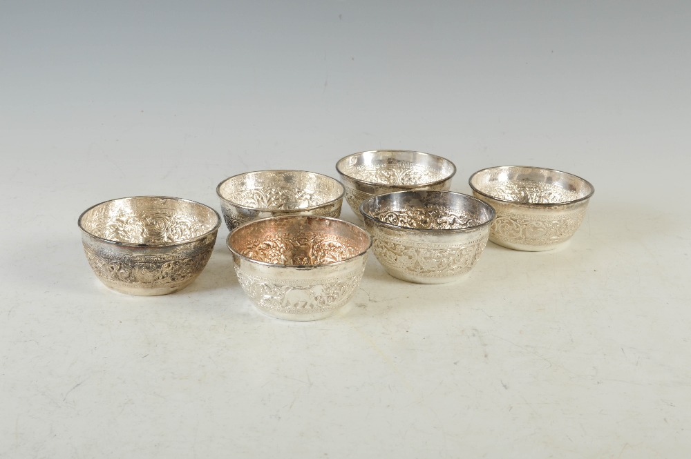 A set of six late 19th/ early 20th century Indian silver finger bowls, with embossed decoration of