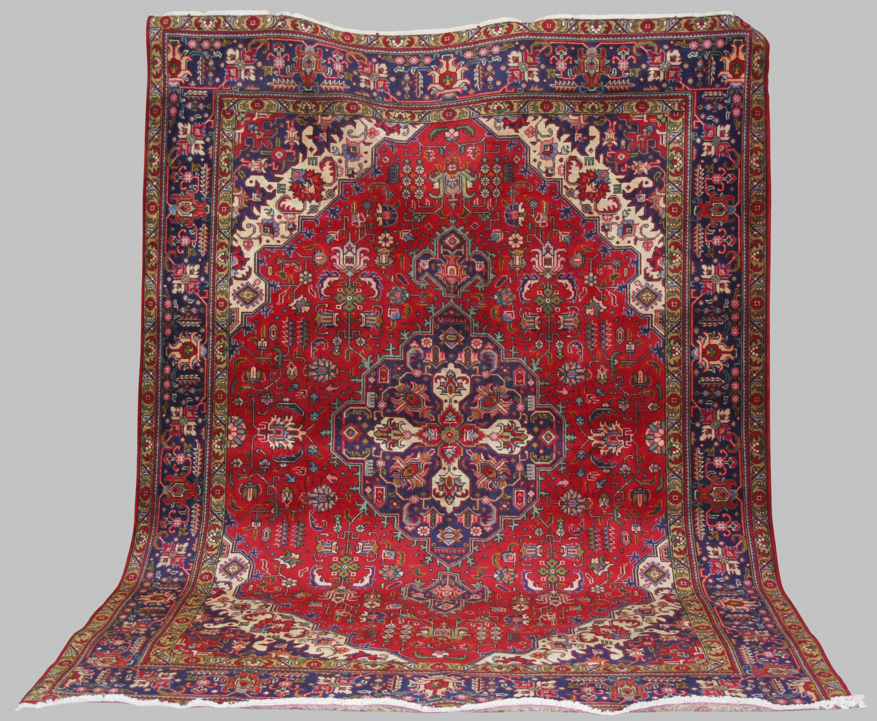 A Persian Carpet, Tabriz, 20th century, the rectangular madder ground centred with a blue