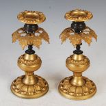 A pair of 19th century Regency style gilt metal candlesticks, with foliate cast canopy to suspend
