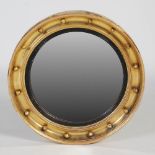 A 19th century giltwood mirror, the convex circular mirror plate within a ball frieze, 63.5cm