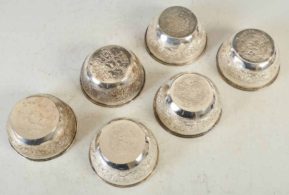 A set of six late 19th/ early 20th century Indian silver finger bowls, with embossed decoration of - Image 3 of 3