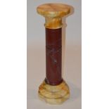 A mottled red and yellow marble pedestal/ column, 20th century, the circular revolving top on a